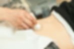A woman receiving an abdominal ultrasound
