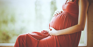 pregnant woman in pink dress 